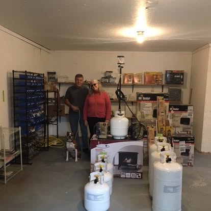 The Brown's Propane owners in their Waldoboro store, surrounded by propane tanks, heaters and gear